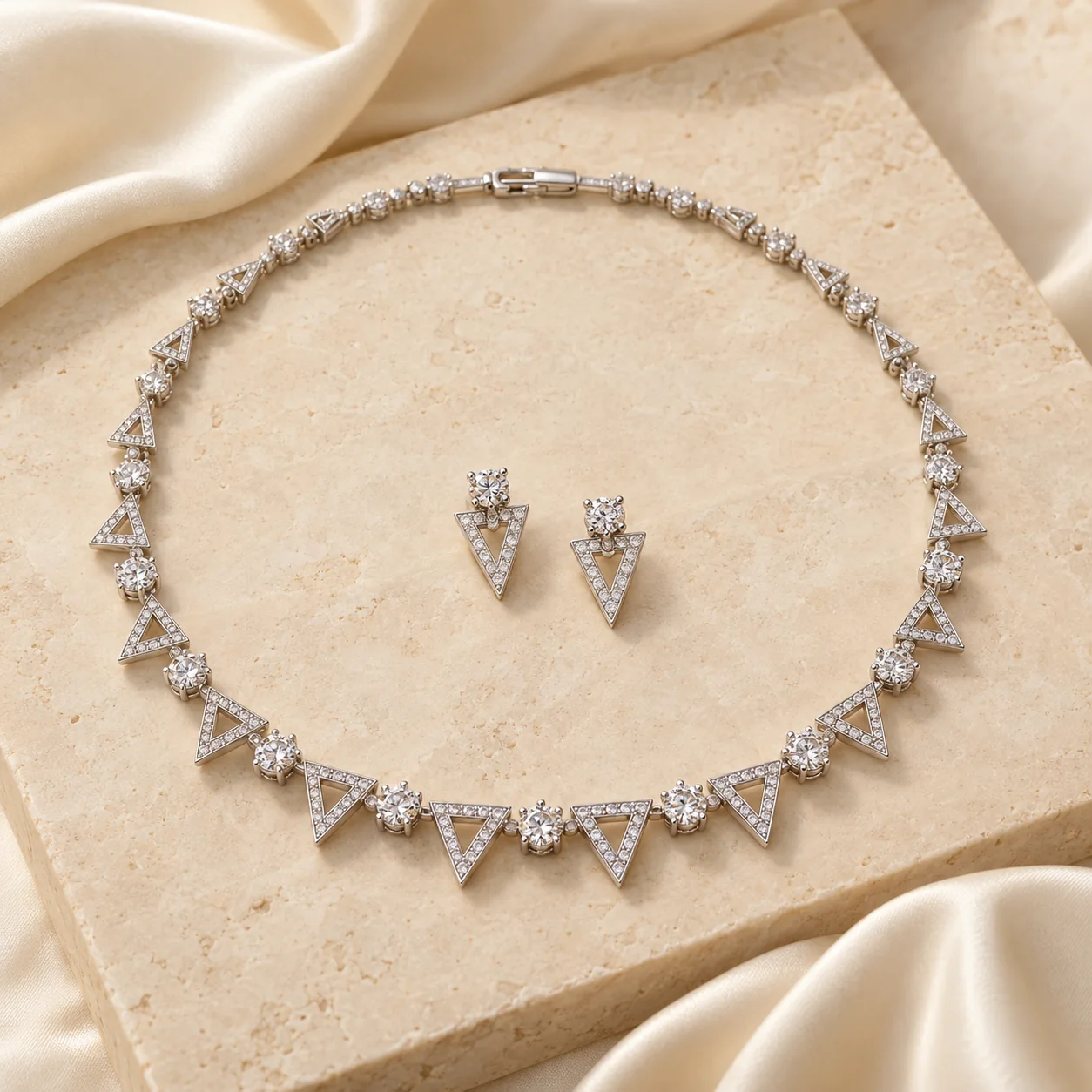 Diamond Jewellery collection - complete white-metal necklace with alternating narrow triangular open frames holding securely bead-set clear stones and round claw-set hinge stones