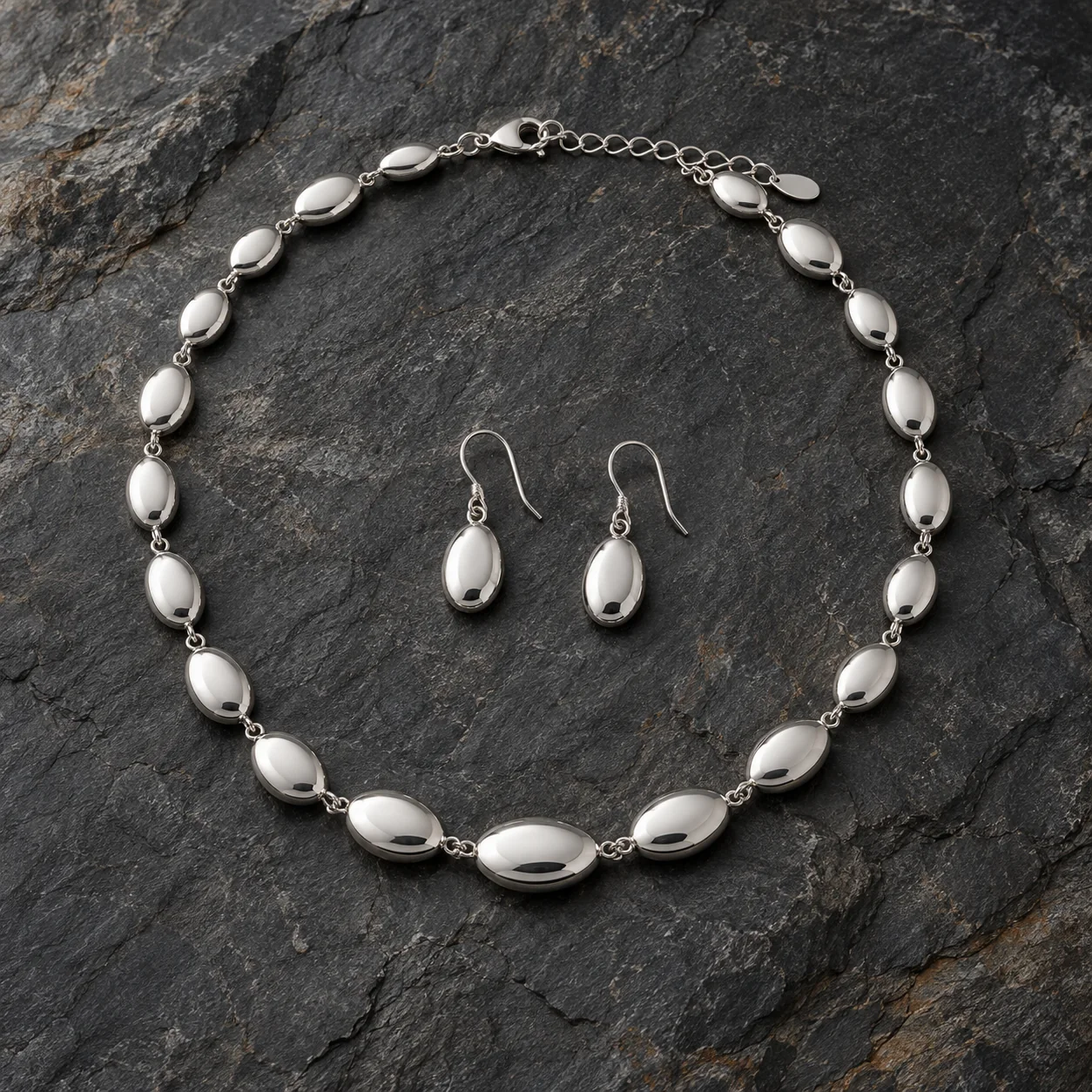 Silver Jewellery collection - complete silver necklace of small smooth oval pebble-shaped links joined by tiny rings, exactly two matching oval pebble drop earrings