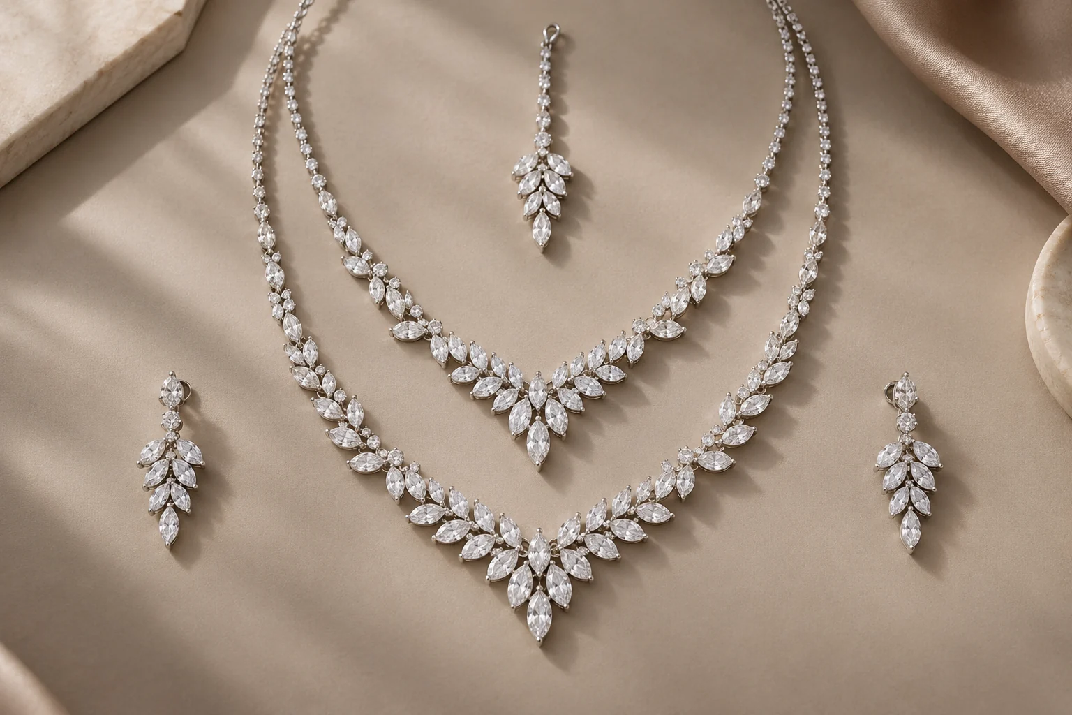 Bridal Diamonds editorial - complete white-metal bridal set: two graduated necklaces of clear marquise stones arranged as narrow pointed chevrons with round hinges, two.