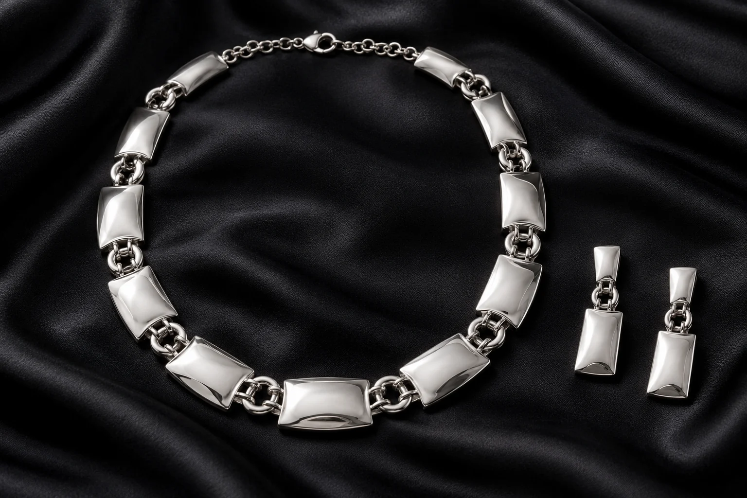 Silver Necklaces editorial - complete polished silver necklace of broad alternating convex rectangular links and fine double round connectors, exactly two matching.