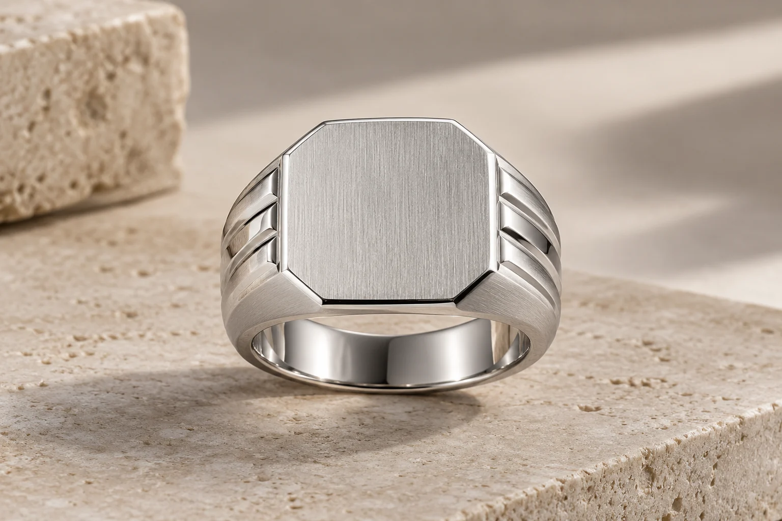 Silver Rings editorial - one thick masculine silver signet ring with a flat octagonal brushed top and stepped polished shoulders, no gemstone or hallmark